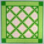 Double Irish Chain wall quilt with shamrock embroidery.