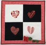 Small wall quilt with heart embroidery on black and white blocks