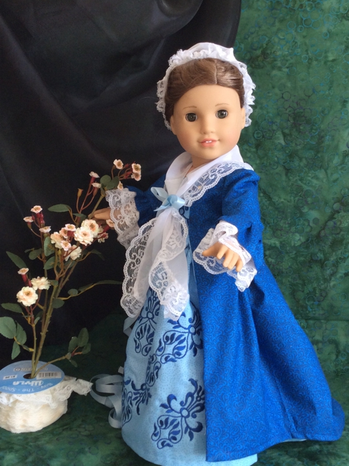 Doll in a finished sacque back outfit.