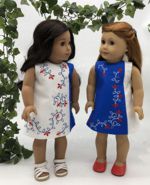 2 dolls in white-and-blue dresses with embroidery
