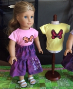 Doll in a t-shirt decorated with butterfly applique