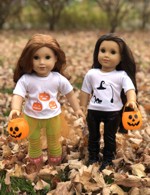 2 doll in white t-shirts embellished with Halloween-themed miniatures