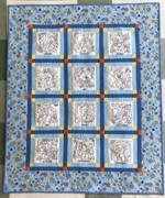 Blue-and-white baby quilt with embroidery
