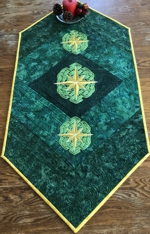 Green Tablerunner with golden Celtic star embroidery.