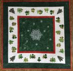 Green, red and white table topper with embroidery