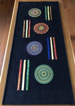 Black tablerunner with circle embroidery in bright colors