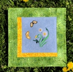 Small summer-themed quilt with ddandelion and butterfly embroidery