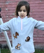 A girl in a sweatshirt decorated with puppies embroidery