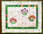 Small wall quilt with flower embroidery
