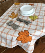 An ivory tablecloth with applique leaves embroidery