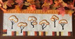 Small wall quilt or table runner with autumn trees embroidery