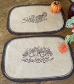 Felt placemats with harvest-themed embroidery.