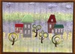 Small quilt with houses applique and tree emboidery