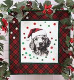 A small Christmas-themed quilt with a golden retriver embroidery.