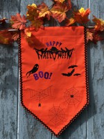 Orange banner with Halloween-themed embroidery