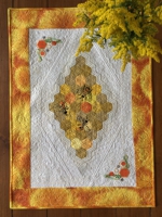 Quilted tablerunner with honeybee embroidery.