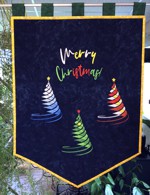 Bright blue banner with Christmas trees embroidery.