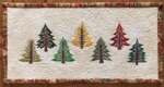 Small wall quilt with pine tree embroidery.