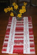 Quilted scrap tablerunner with redwork embroidery