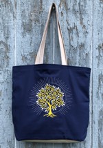 Dark blue tote with radiant tree embroidery on the front panel.