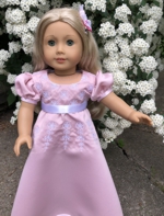 A doll in a pink Regency style dress