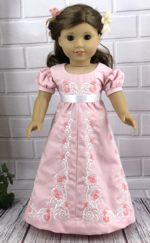 A 18-inch doll in a salmon pink Regency style dress with embroidery.