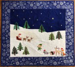 Blue and white quilt with embroidery of Santa, elf and small forest animals