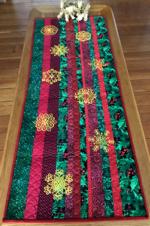 Christmas-themed scrap tablerunner with embroidery