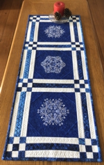 Winter-themed blue tablerunner with snowflake embroidery