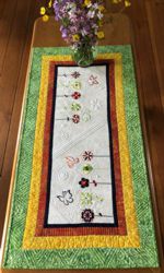 Green-yellow-red tablerunner with flower and butterfly emboirdery