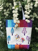 Quilted tote bag with unocirn and tree embroidery