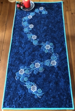 Blue tablerunner with embroidery.