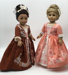 2 dolls in a 18-century gowns embellished with embroidery