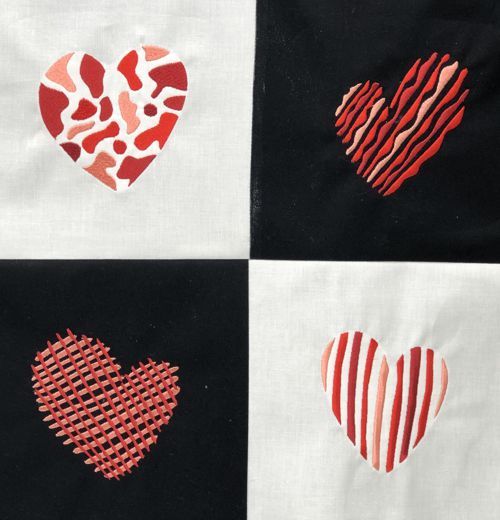 Close-up of the stitch-outs of hearts in the black and white blocks