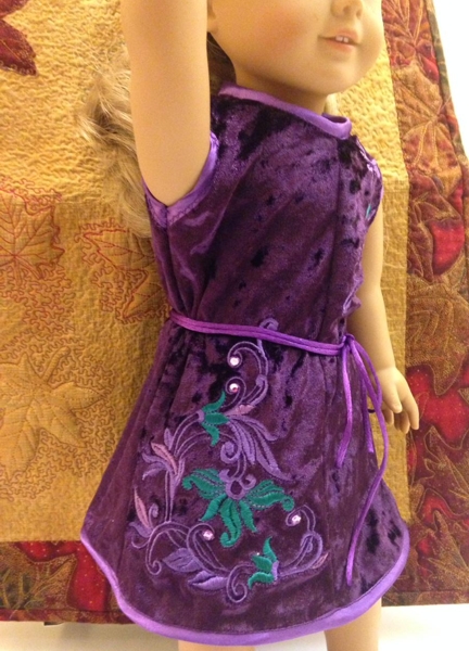 18-inch doll modeling the machine embroidered dress, side embroidery