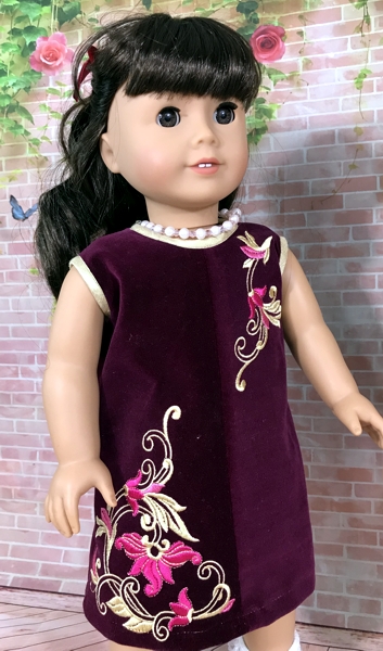 18-inch doll modeling the machine embroidered dress