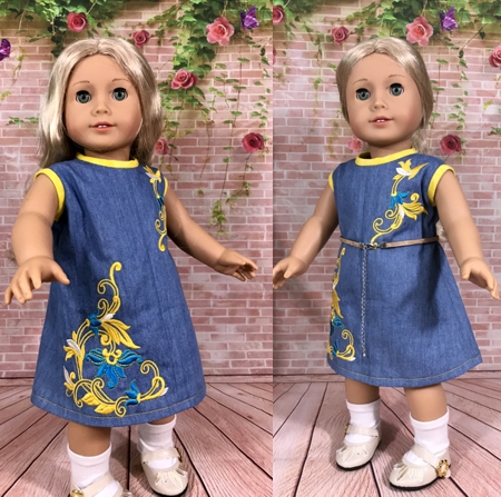 Two 18-inch dolls modeling the machine embroidered dresses