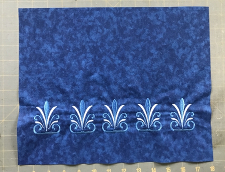 Photo of the rayal blue rectangle with stitch-outs of the offered design