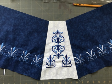 Photo showing the unfolded skirt with the white embroidered inset in the center
