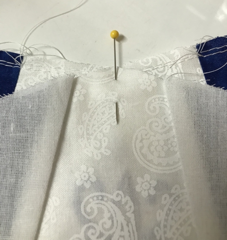 Photo showing how to attach stomacher to the white inset of the skirt