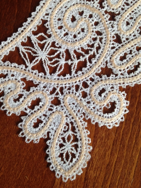 Photo of the stitch-out of the collar. Close-up of the lace.