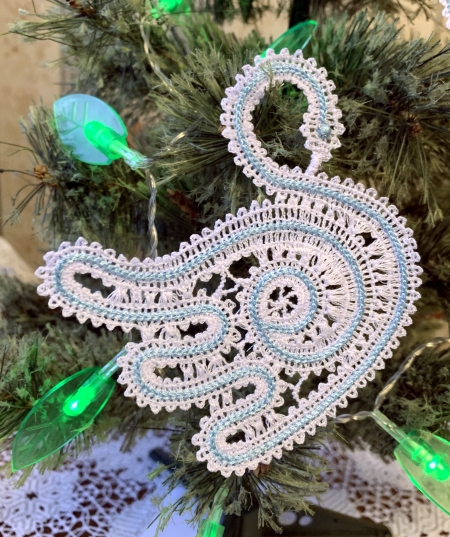 Photo of the stitch-out of the second swan design on a Christmas tree branch