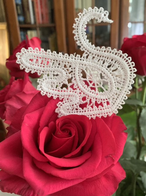 Photo of the stitch-out of the first swan design on a rose