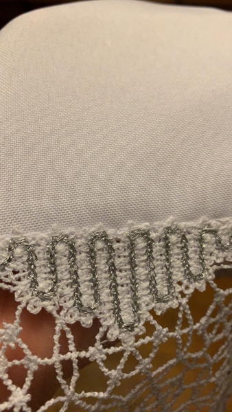 A close-up photo of the lace attached to the fabric from the right side.