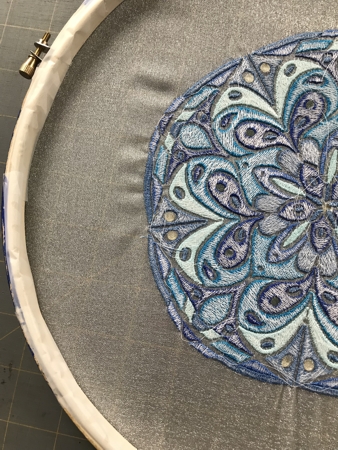 Photo showing how to finish the raw edges of the embroidery in the hoop.
