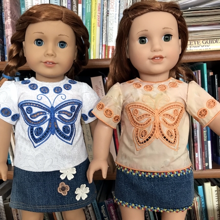 Two 18-inch dolls modeling the machine embroidered blouses