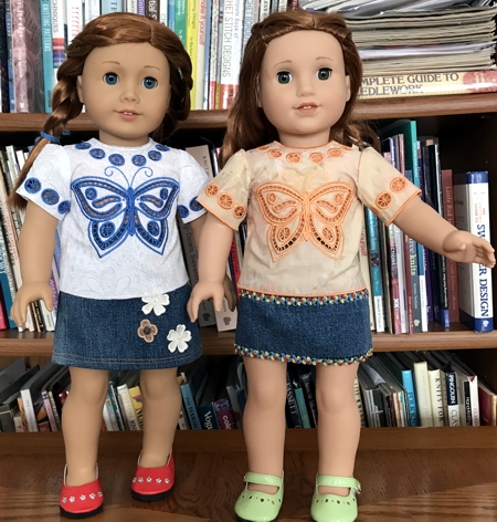 Two 18-inch dolls modeling the machine embroidered blouses