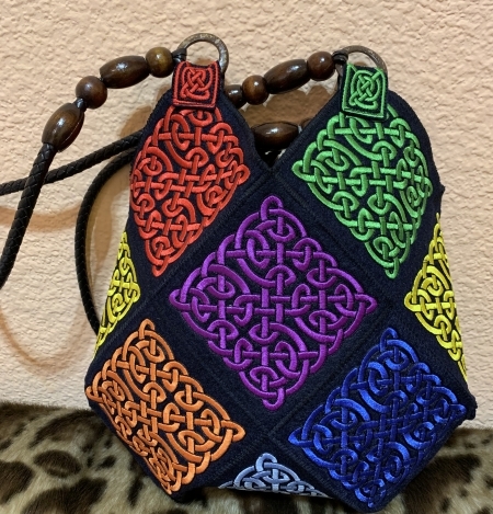 Finished bag made out of embroidered Celtic motifs.
