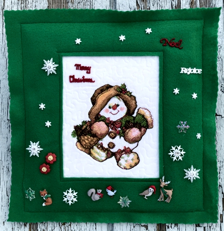 Snowman with Gifts design in a felt frame.