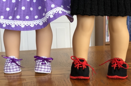 Doll shoes shown on the feet of American Girl dolls.